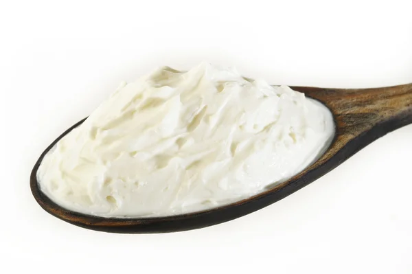 Cream cheese in wooden spoon — Stock Photo, Image