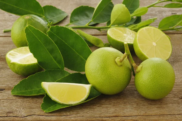 Lime fruit on wooden background — Stock Photo, Image