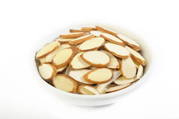 Sliced raw almonds in white bowl — Stock Photo, Image
