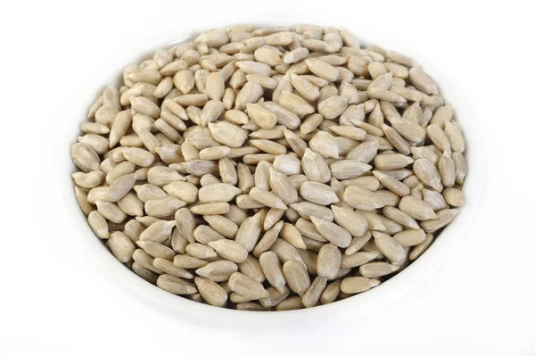 Peeled sunflower seeds in white bowl — Stock Photo, Image