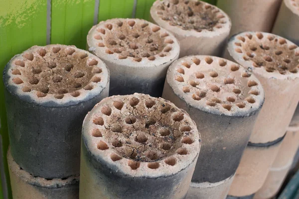 Coal briquet cylindrical solid fuel mixed. briquettes are piled up