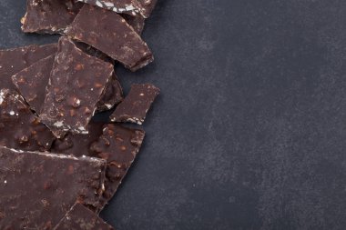 Kırık çikolata parçaları beyaz arka planda izole edilmiş.