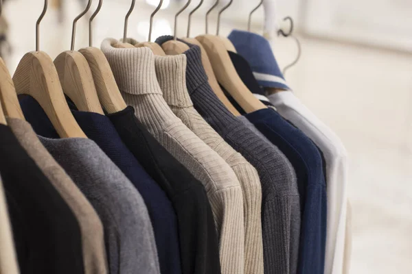 Warm winter ladies knit cloth on hangers in a clothing store