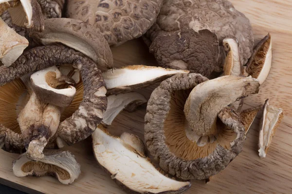 Pile of dried shiitake mushroom isolated on wooden background