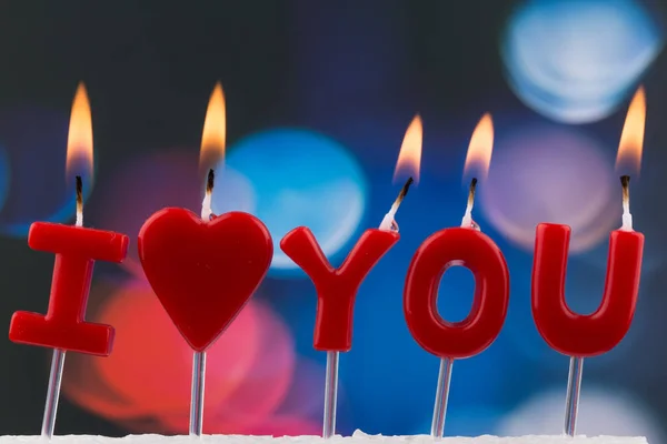 red burning candles making \'I love you\' isolated