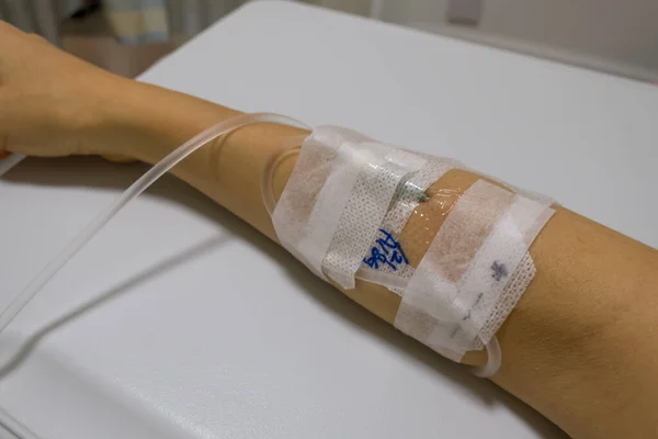 woman in hospital getting an immunoglobulin infusion with intravenous drip