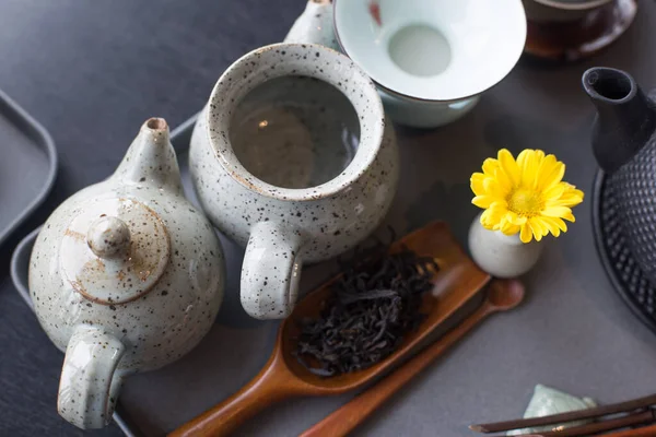 Asian food background with a tea set, cups, tea leaves, and teapot. — Stock Photo, Image