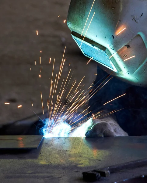 sparks from welding when worker makes a welding