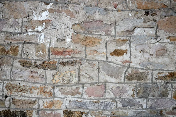 Texture di un vecchio muro di pietra con cuciture in muratura — Foto Stock