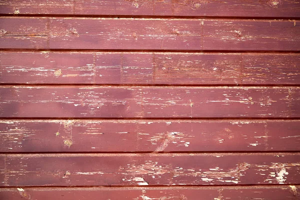 Eski bir ahşap duvarın arkaplan dokusu ve boyası soyulmuş.