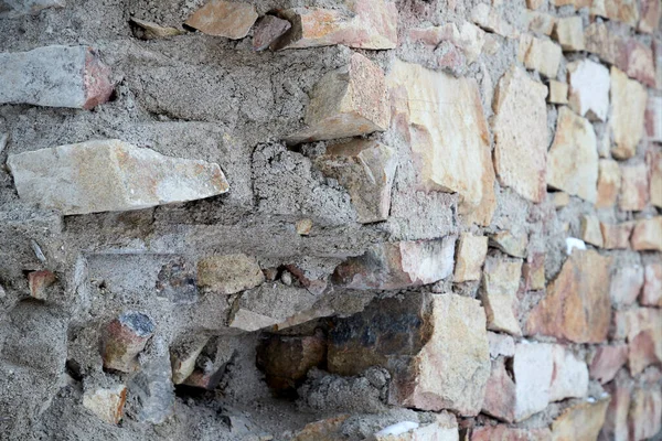 Textuur van een oude gebroken stenen muur met metselwerk naden — Stockfoto