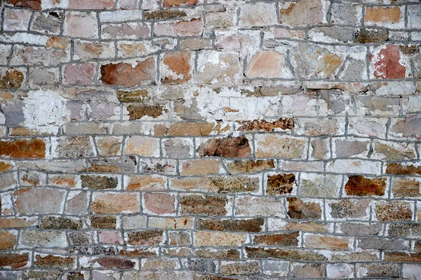 Texture di un antico muro in pietra con cuciture in muratura e tracce di stucco — Foto Stock