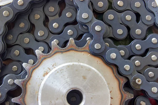 close up background of sprocket with hardened teeth and chain