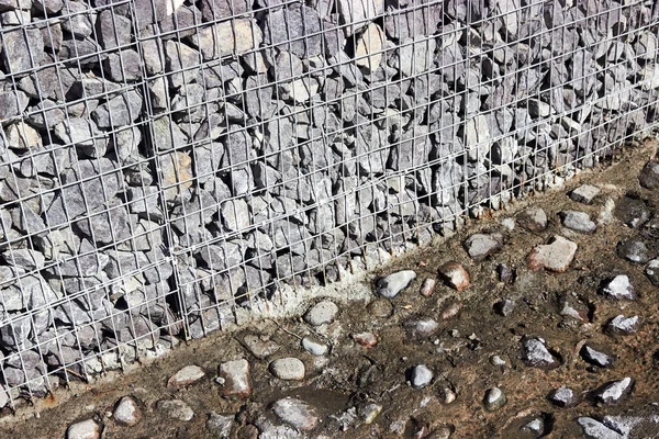 Bodem en rivierbedding met stenen en gabions — Stockfoto