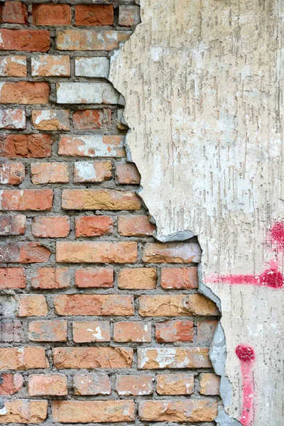 Aged old brick wall with peeling concrete plaster — Stok Foto