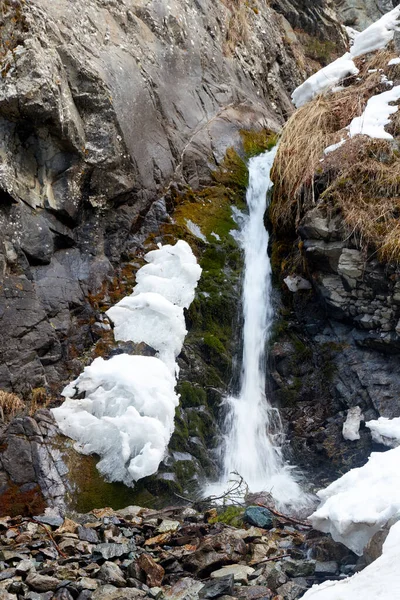 Bir dağ deresinde şelale. İlkbaharın başlarında kar eriyor
