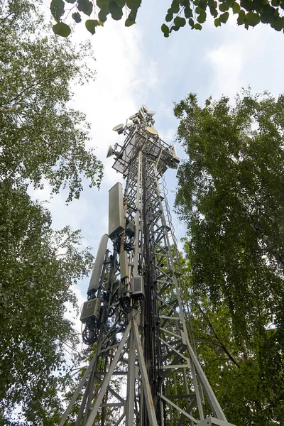 telecommunications tower of cellular communication among the trees. mobile communication technology