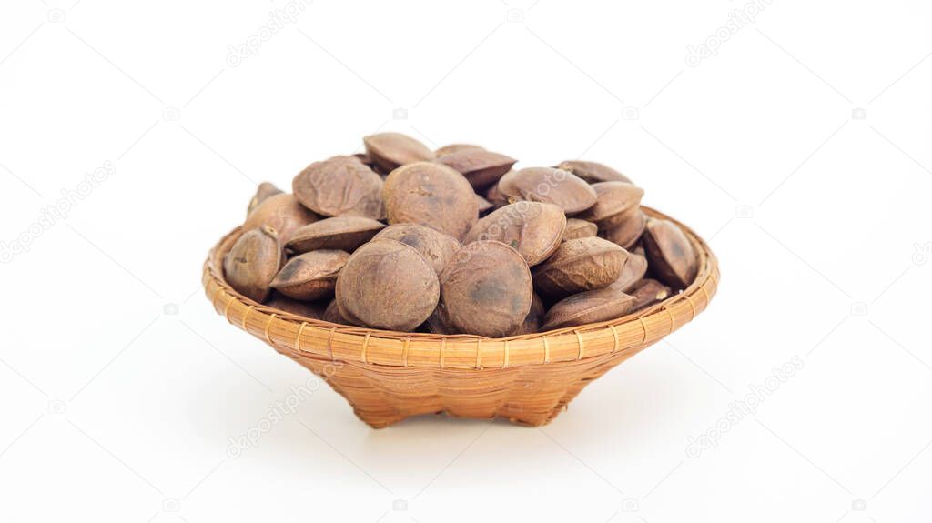 Sacha Inchi seeds in a basket on a white background.