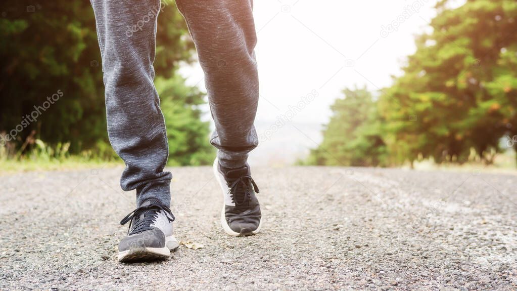 Men wears sneakers and jogging in a garden.