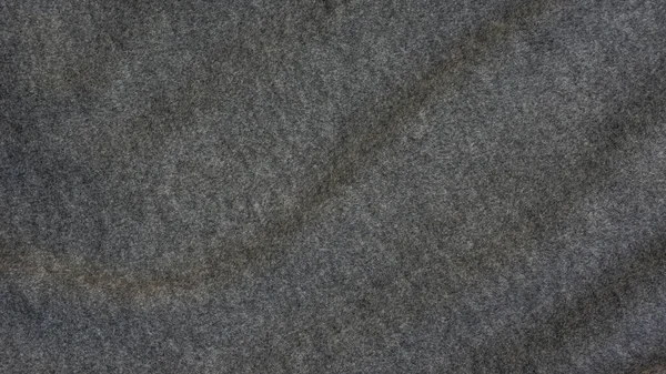 Close up of dark gray soft fabric for a background.