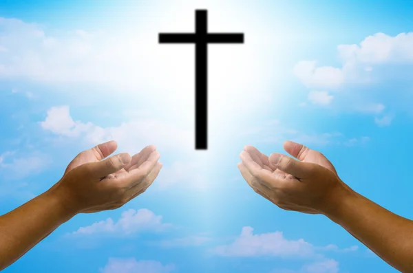 Open hands praying the cross on blur sky background. — Stock Photo, Image