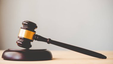 Law theme, mallet of the judge, law enforcement officers, evidence-based cases and documents taken into account.	