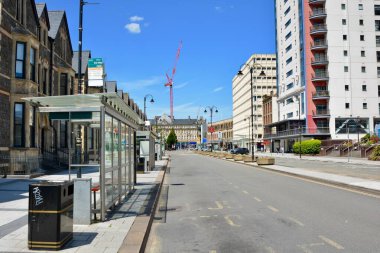 URBAN LANDSCAPE, COVID 19 CARDIFF ŞEHRİ, Yürürken kilitleniyor. Cardiff Şehir Merkezi kapatıldı yollar boş, dükkanlar kapalı, sadece ıssız yolları ve bölgeleri egzersiz için kullanan bisikletçiler var. WALES turistlere kapalı.
