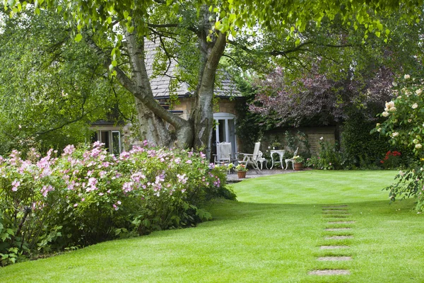 Summer cottage garden with a small patio — Stock Photo, Image