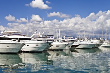 Row of luxury yachts mooring in a harbour clipart
