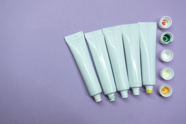 Beyaz boya tüpleri, açık kapaklar. Akrilik boya. Düz.