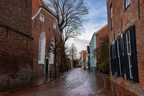 The view into a street in the center of the small port town Greetsiel with beautiful red brick buildings