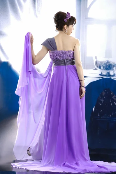 Beautiful bride in purple dress — Stock Photo, Image