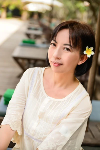 Female with frangipani — Stock Photo, Image