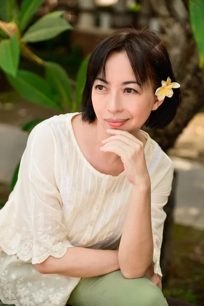 Female with frangipani — Stock Photo, Image