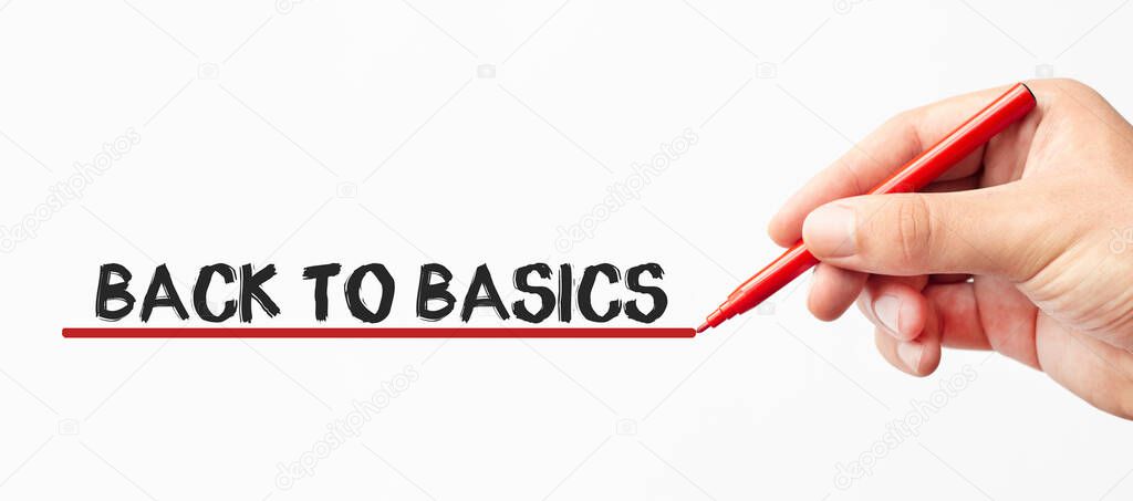 Hand writing BACK TO BASICS with red marker. Isolated on white background. Business, technology, internet concept. Stock Image