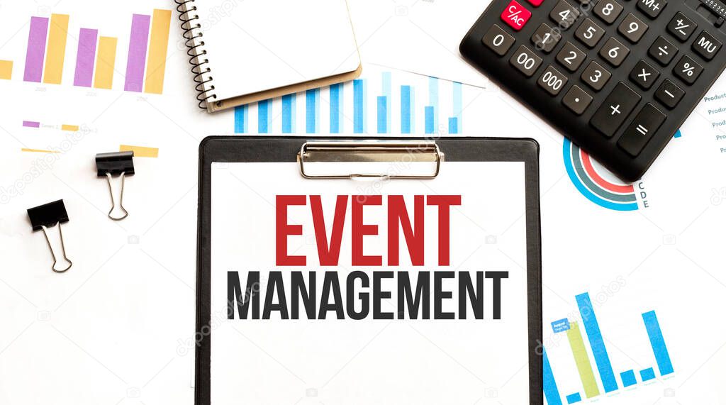 Paper plate with text EVENT MANAGEMENT. Diagram, calculator, notepad and white background