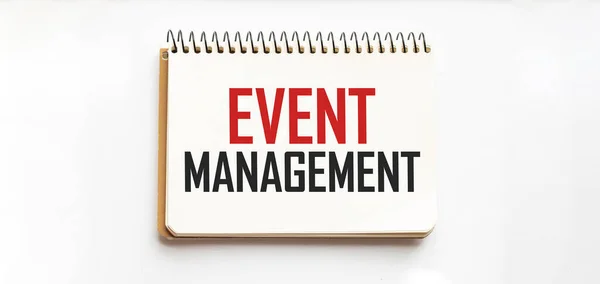 Notepad with text EVENT MANAGEMENT. White background. Business