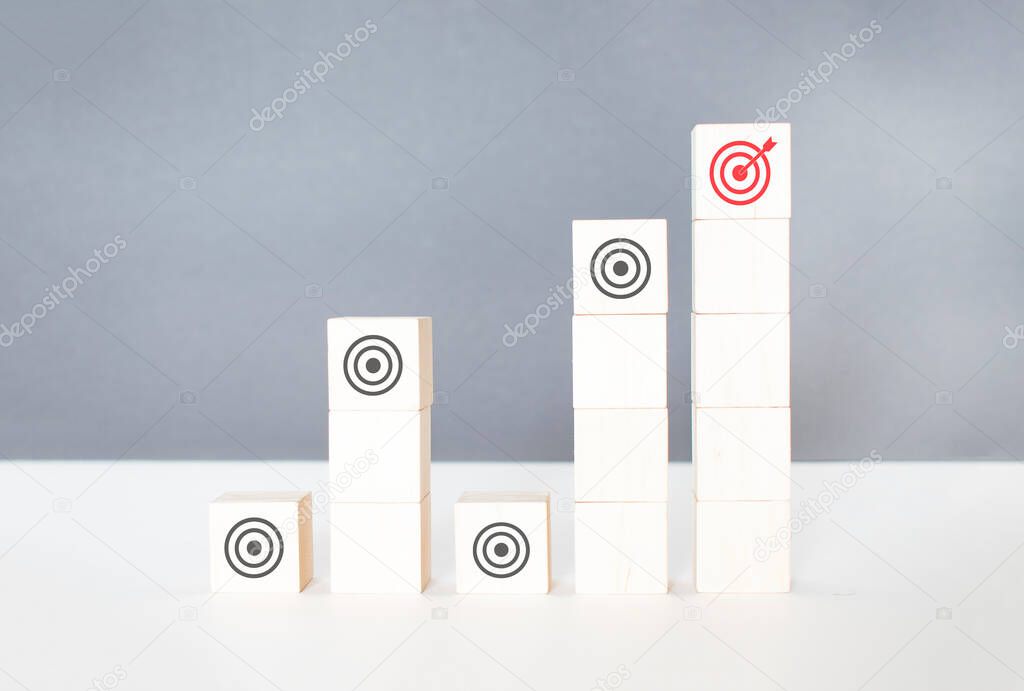 Business strategy concept. Hand arranging symbol with goal icon on wood cube block,Set target, Research and Plan,Teamwork.