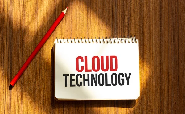Red pen and notepad with text CLOUD TECHNOLOGY in the white background
