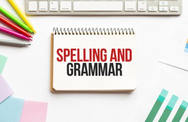 İşadamı not defterini yazım ve gramer ile birlikte tutuyor. Beyaz arka plan. İş dünyası