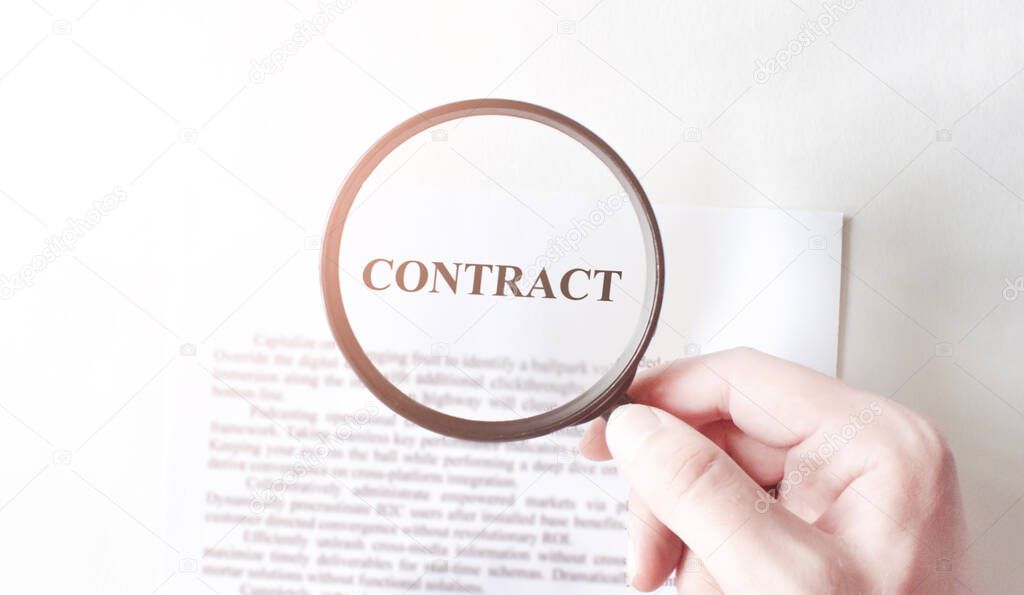 Contract with pen and magnifying glass. Business concept