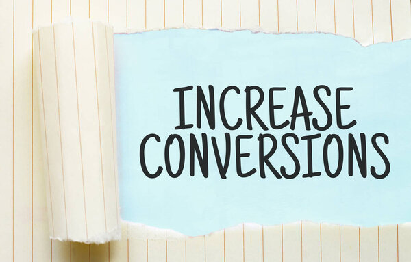The text increase conversions appearing behind torn white paper