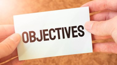 Bir iş adamının elindeki beyaz kart kâğıdına yazılmış bir yazı. Özet konsepti. kırmızı ve beyaz kağıt