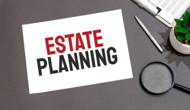 Emlak Planlama işareti ile yazılmış büyüteç, hesap makinesi, kalem, bitki ve defter üst görünümü