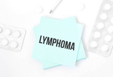 Üzerinde LYMPHOMA yazılı mavi kart hap ve kalem olan bir masada, tıbbi konsept, üst görünüm