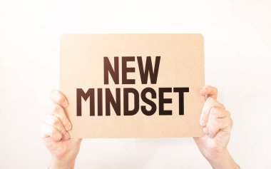 Closeup Business man hand holding show blank paper sheet mock up empty white board space for shouting text rule or protest word. Text NEW MINDSET