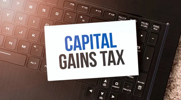 White Paper Sheet Text Capital Gains Tax Black Laptop — Stock Photo, Image