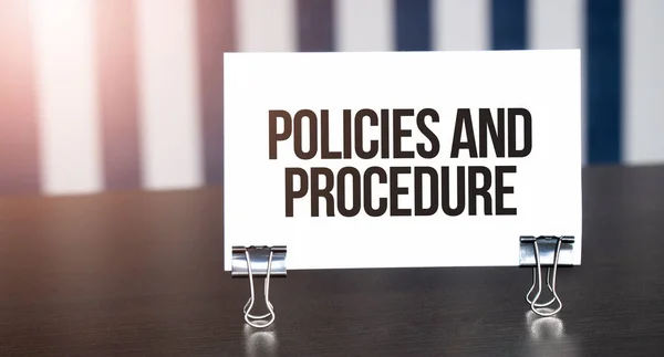 Policies Procedure Sign Paper Dark Desk Sunlight Blue White Background — Stock Photo, Image