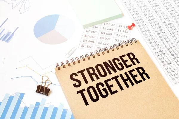 Notepad with text stronger together. Diagram and white background