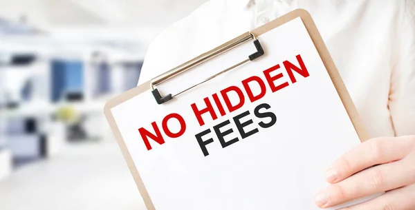 Text No Hidden Fees on white paper plate in businessman hands in office. Business concept